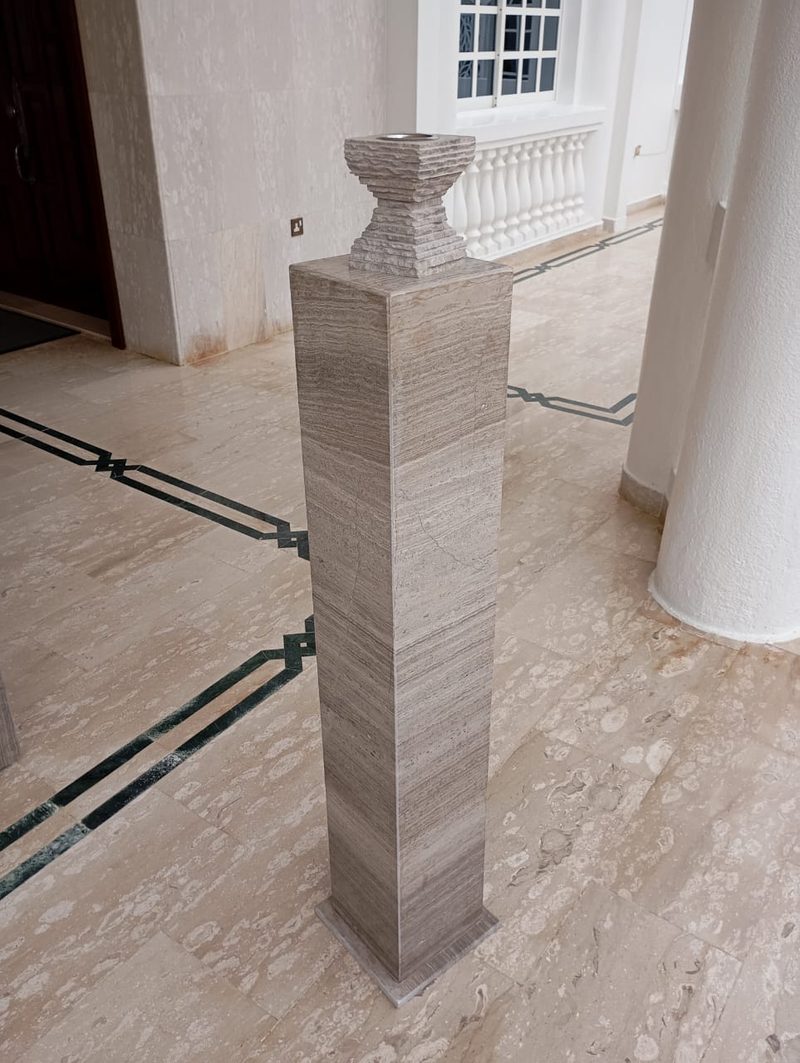 Tall stone pedestal with a turned cap in a finished villa interior — Reef Al Ghadeer, Al Ain