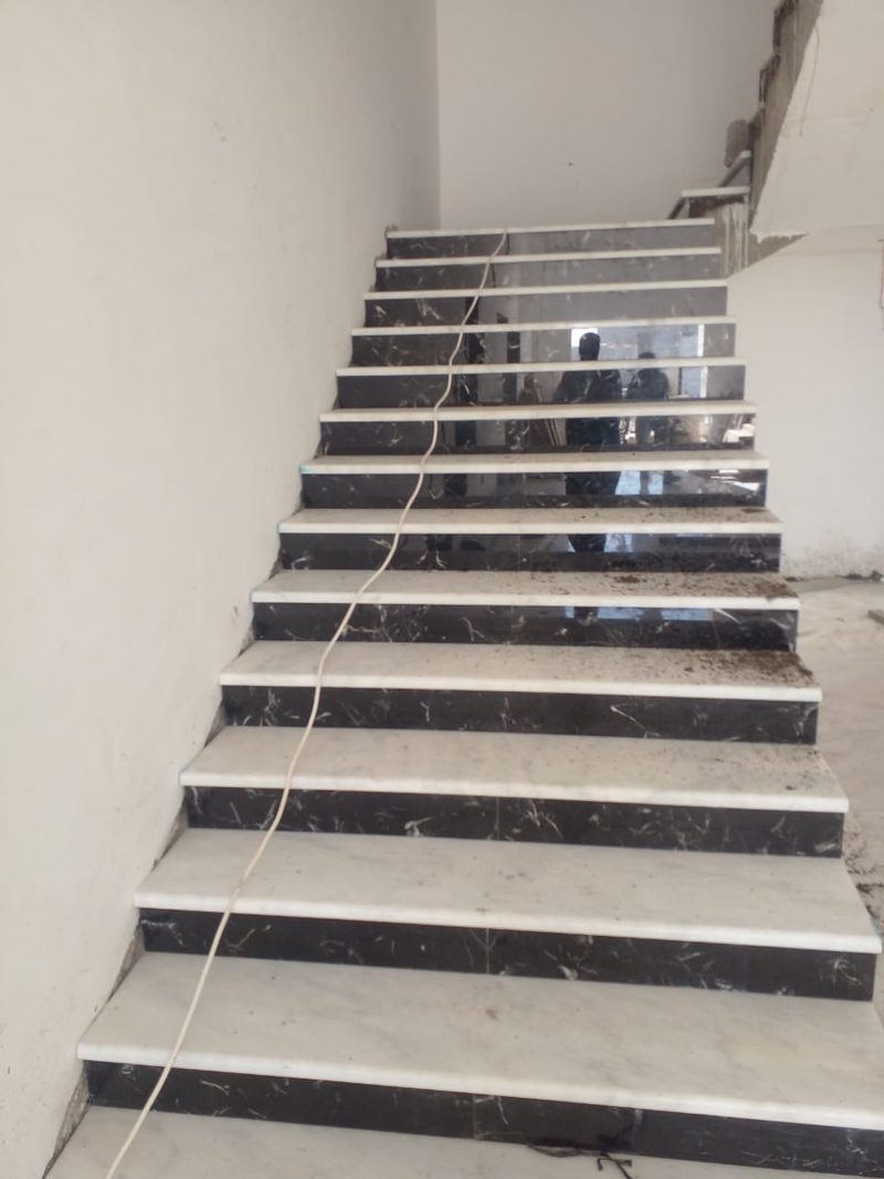 Marble stair treads and risers part-way through installation — Reef Al Ghadeer, Al Ain