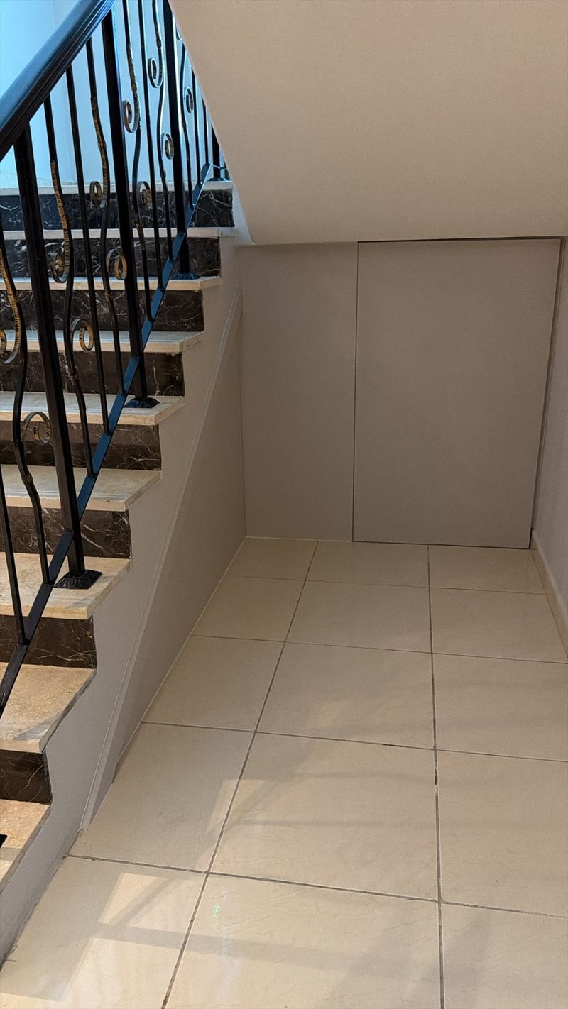 Finished partition and tiled floor beneath a staircase in a villa — Reef Al Ghadeer, Al Ain