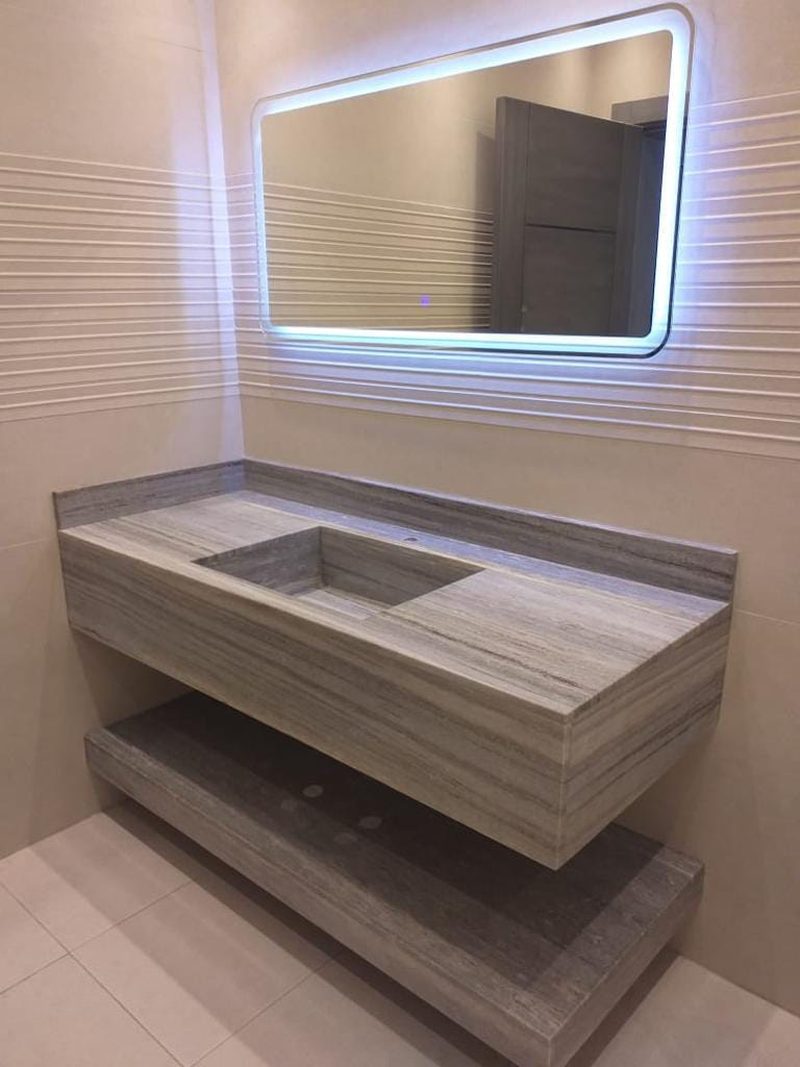 Stone vanity unit beneath a backlit mirror in a finished washroom — Reef Al Ghadeer, Al Ain